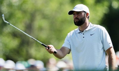 Defending champion Scottie Scheffler prepares to play a shot in the first round of the Masters at Augusta National