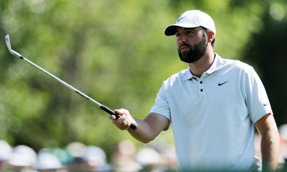 Defending champion Scottie Scheffler prepares to play a shot in the first round of the Masters at Augusta National