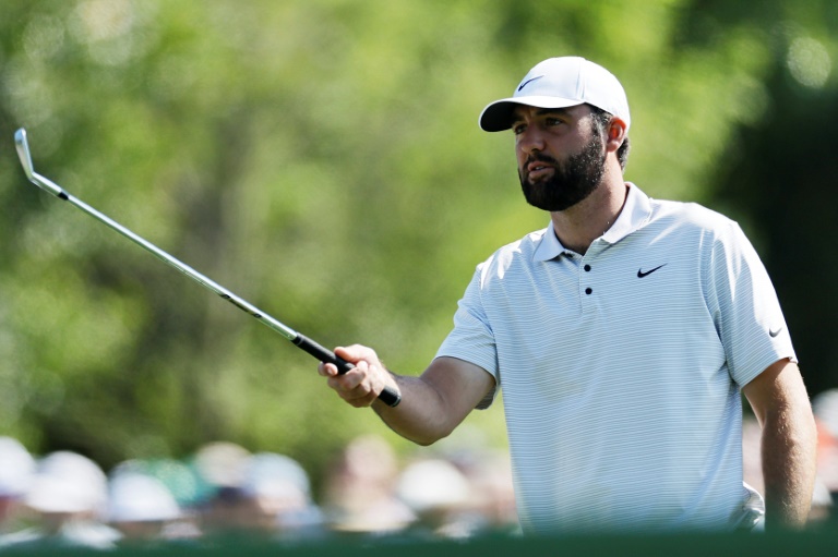 Defending champion Scottie Scheffler prepares to play a shot in the first round of the Masters at Augusta National