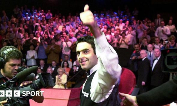 Ronnie O'Sullivan smiles and celebrates with a thumbs-up gesture after winning the 2001 World Championship