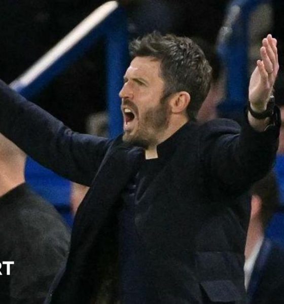 Man Utd manager Michael Carrick holds his arms out