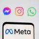 Facebook's new rebrand logo Meta is seen on smartpone in front of displayed logo of Facebook, Messenger, Intagram, Whatsapp, Oculus in this illustration picture taken October 28, 2021.