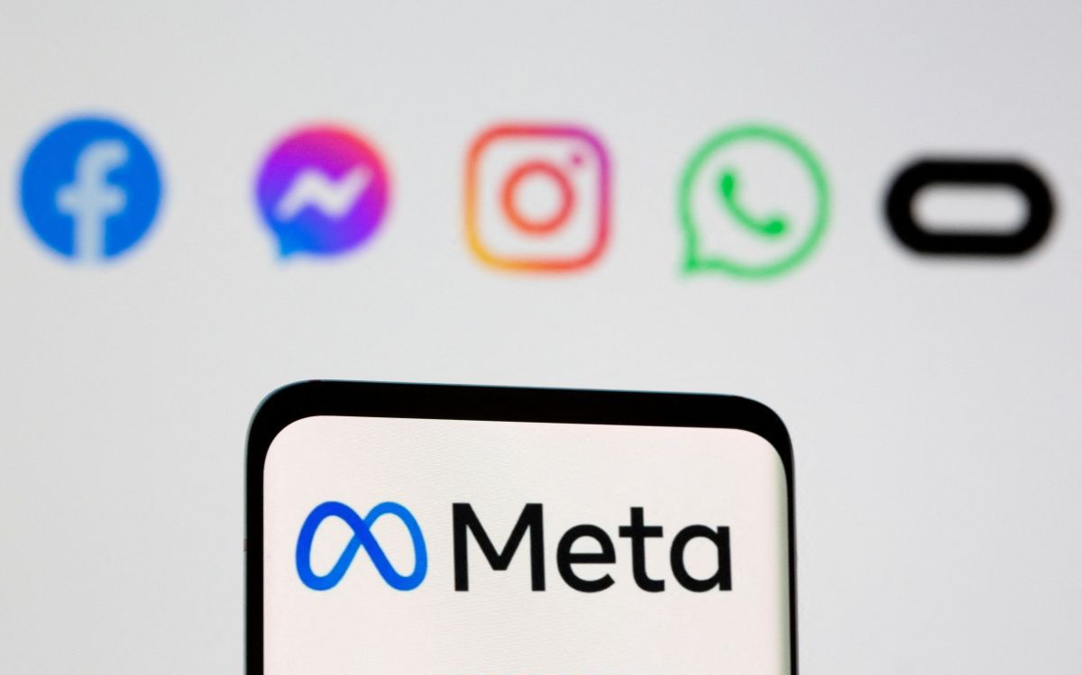 Facebook's new rebrand logo Meta is seen on smartpone in front of displayed logo of Facebook, Messenger, Intagram, Whatsapp, Oculus in this illustration picture taken October 28, 2021.