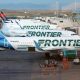 Frontier Airlines planes stand at gates on the A Concourse at Denver International Airport in Denver.