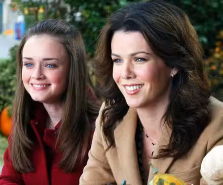 Rory and Lorelai smiling next to each other in Gilmore Girls.