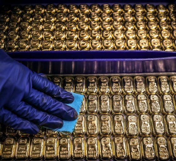 Gold prices hit a record high on a rush into safe havens and helped by the weaker dollar