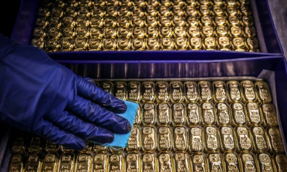 Gold prices hit a record high on a rush into safe havens and helped by the weaker dollar