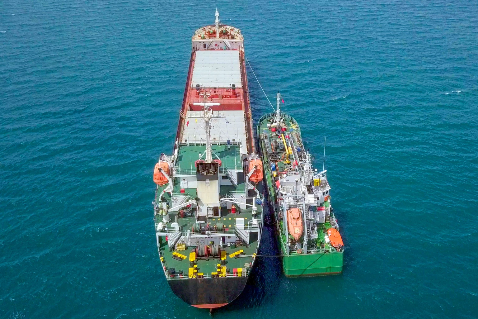 Refuelling at sea, Aerial image of a Small Oil products ship fuelling a large Bulk carrier.
