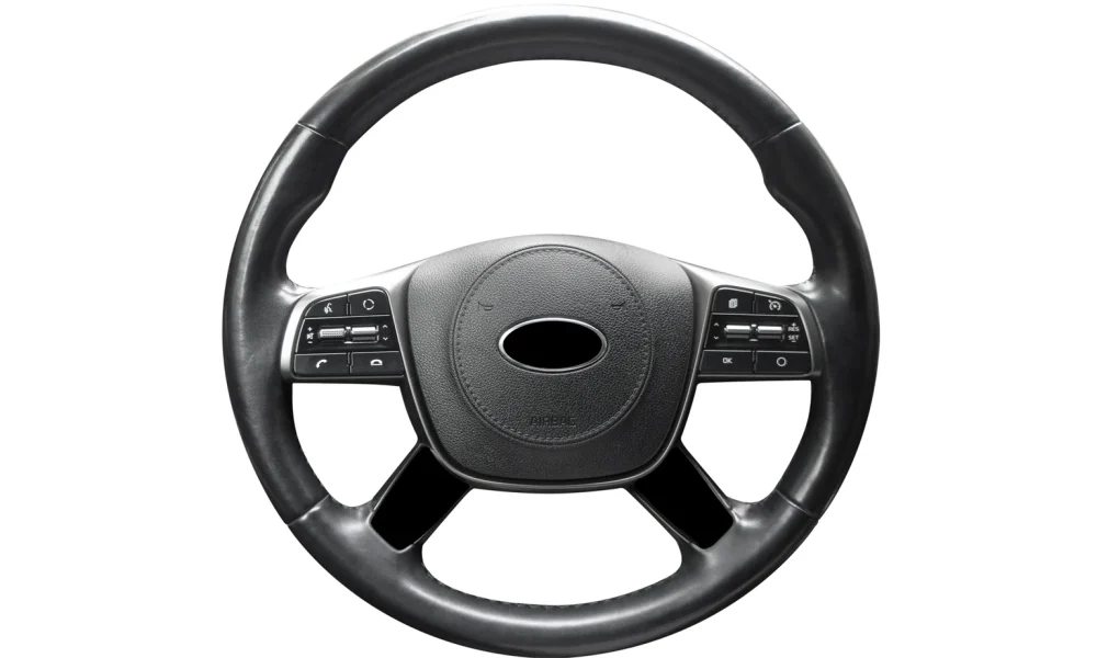 Modern car interior. Steering wheel with media phone control buttons isolated on white background. Car interior details. Steering wheel isolated on white background