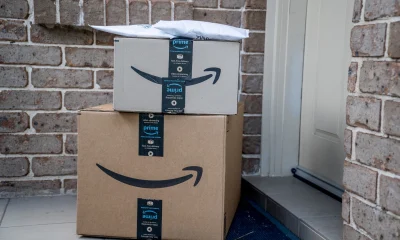 Amazon prime boxes and envelopes delivered to a front door of residential building