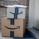 Amazon prime boxes and envelopes delivered to a front door of residential building