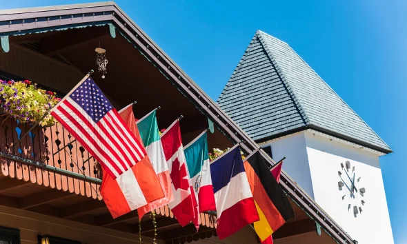 Clock Tower and Chalet Building with Flags in Vail, Colorado