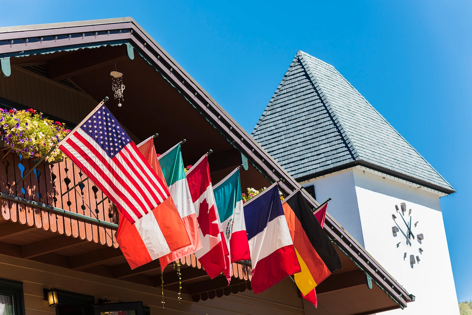 Clock Tower and Chalet Building with Flags in Vail, Colorado