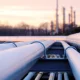 steel long pipes in crude oil factory during sunset