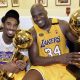 Kobe Bryant (L) of the Los Angeles Lakers holds the Larry O'Brian trophy as teammate Shaquille O'Neal (L) hold the MVP trophy after winning the NBA Championship against Indiana Pacers 19 June, 2000