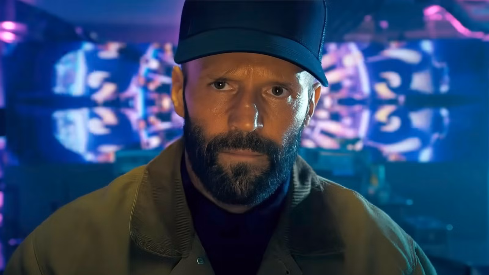 Jason Statham wears a hat in a club in The Beekeeper