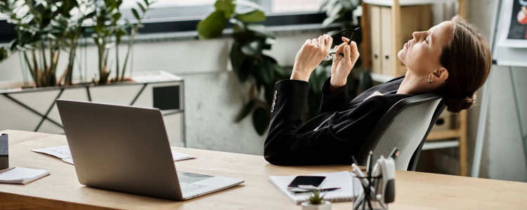 stressed out woman reclines in her chair, she's having a midlife career crisis