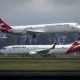 Net profit at Australia's Qantas dropped 28 percent for the fiscal year