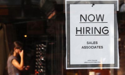The number of job openings rose to 5.5 million in January. In this photo, a “Now Hiring” sign hangs on the door of the Urban Outfitters store at Quincy Market in Boston, Sept. 5, 2014.