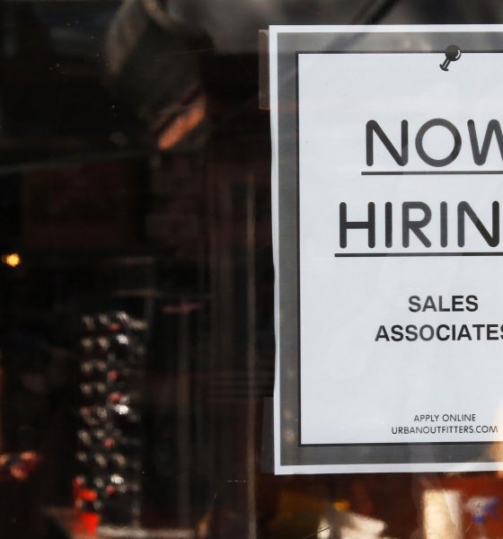 The number of job openings rose to 5.5 million in January. In this photo, a “Now Hiring” sign hangs on the door of the Urban Outfitters store at Quincy Market in Boston, Sept. 5, 2014.