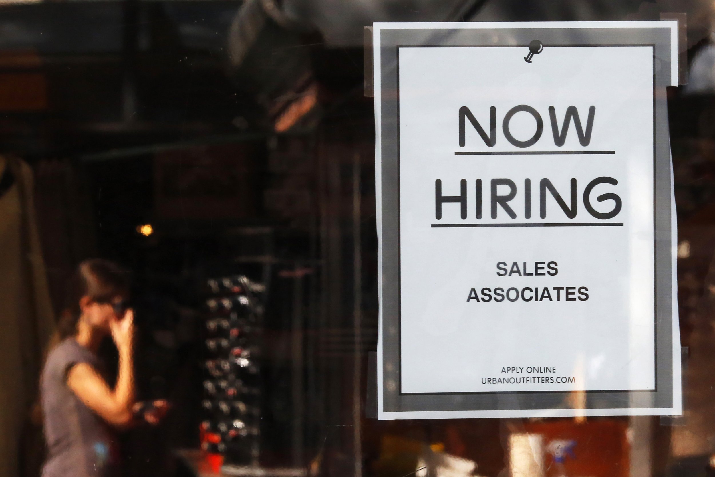 The number of job openings rose to 5.5 million in January. In this photo, a “Now Hiring” sign hangs on the door of the Urban Outfitters store at Quincy Market in Boston, Sept. 5, 2014.