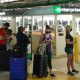 People wait in line at an Enterprise rental agency at Miami International Airport in April 2021