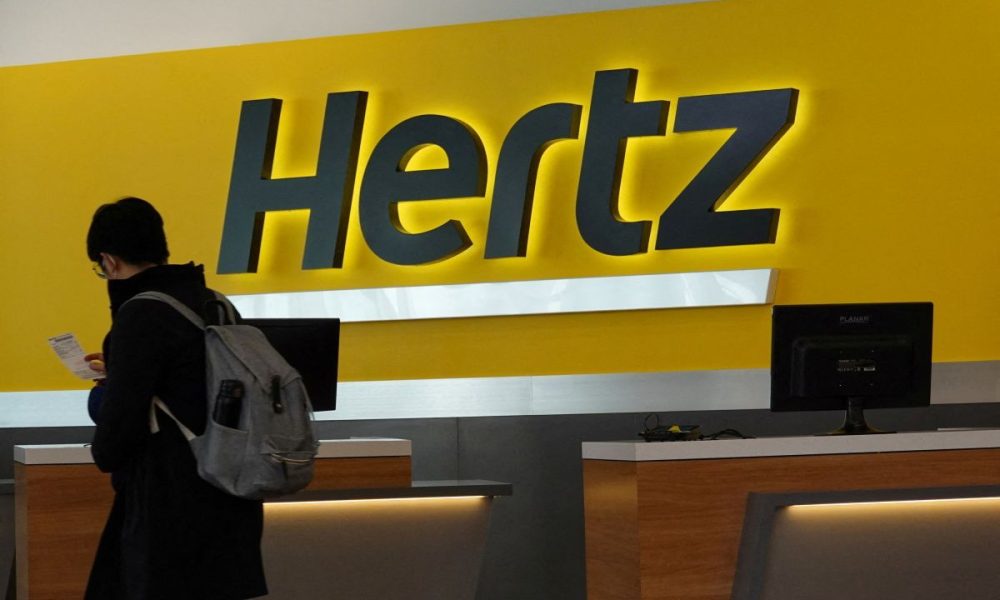 A person walks by the counter of Hertz rental car at John F. Kennedy International Airport in Queens, New York City, U.S., March 30, 2022.