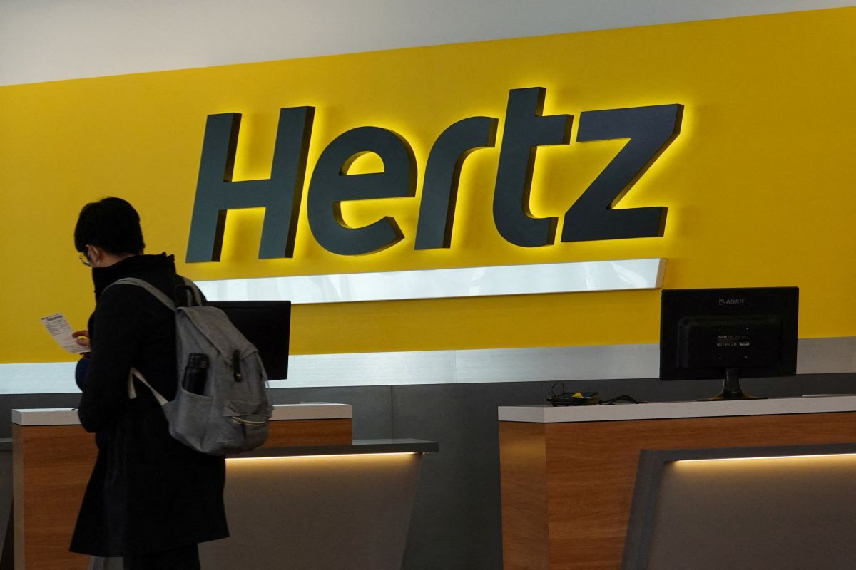 A person walks by the counter of Hertz rental car at John F. Kennedy International Airport in Queens, New York City, U.S., March 30, 2022.
