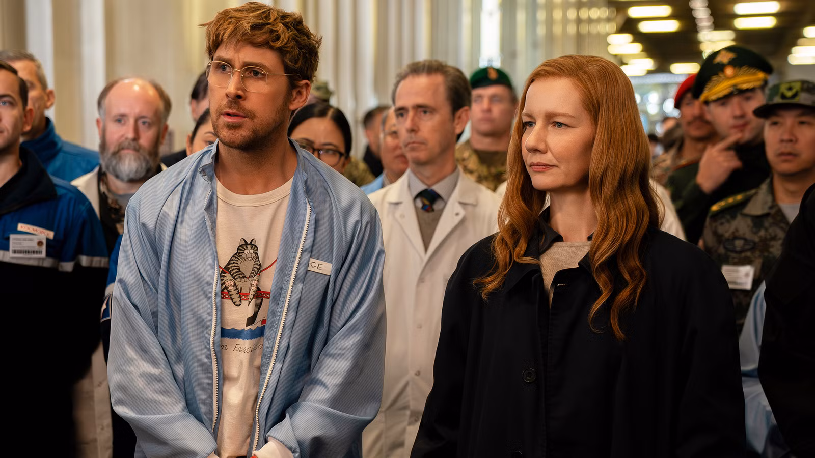 Ryland Grace is being briefed while standing next to Eva Stratt.