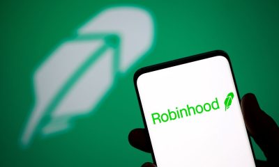 Robinhood logo is seen on a smartphone in front of a displayed same logo in this illustration taken, July 2, 2021.