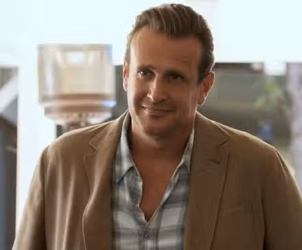 Jason Segel as Jimmy standing outside with a slight smile in Shrinking Season 3