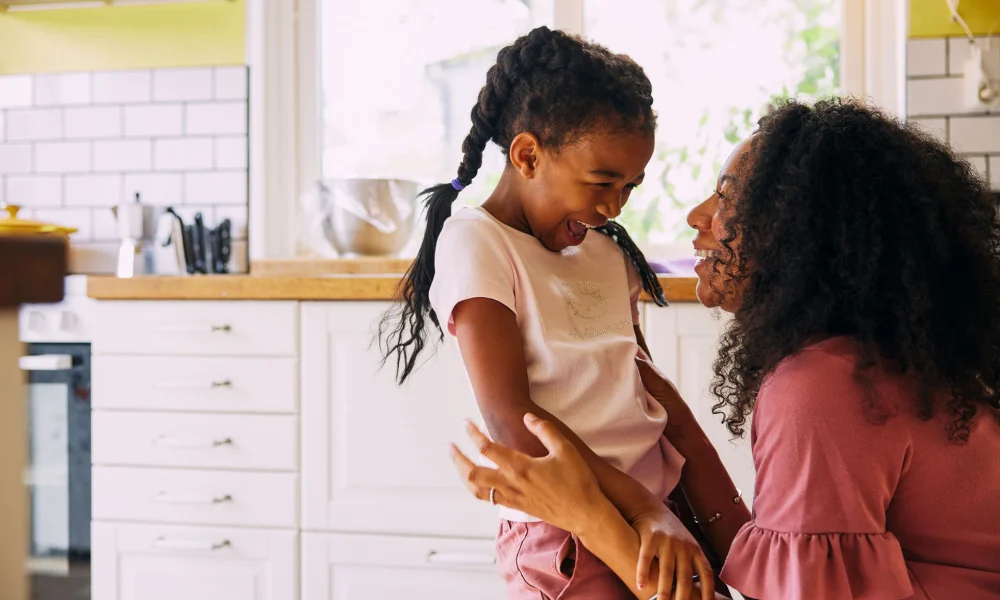 Single mother and daughter embracing