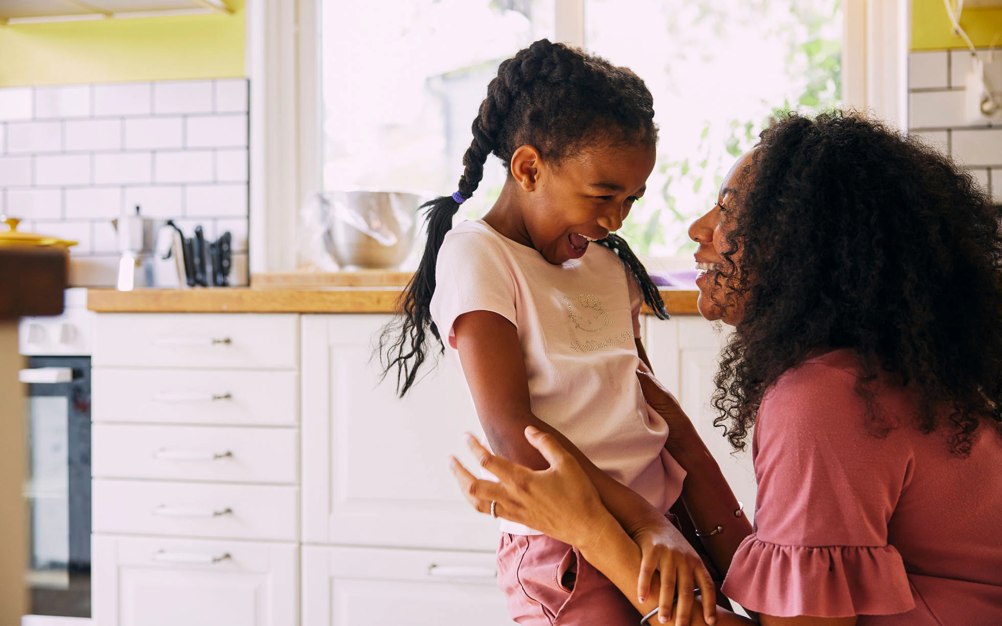 Single mother and daughter embracing