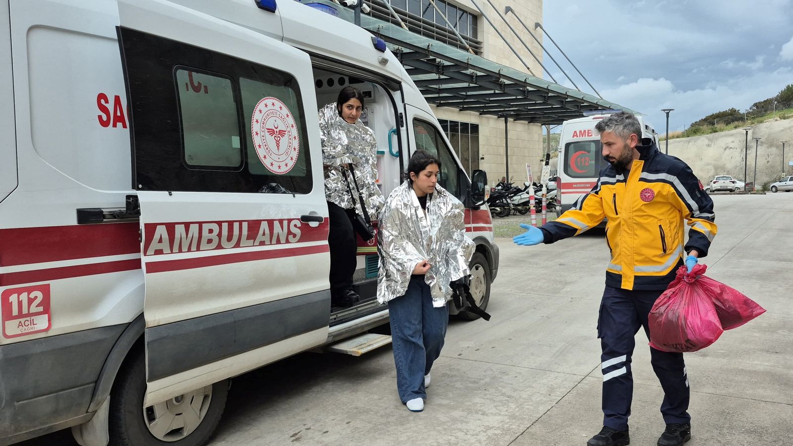 Rescued migrants, whose boat had capsized, arrive at a hospital in Bodrum, Turkey. Pic: Reuters