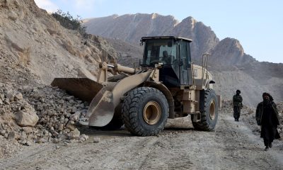 An excavator clears a road following a 2025 quake in Afghanistan's Balkh province. Pic: Reuters