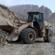 An excavator clears a road following a 2025 quake in Afghanistan's Balkh province. Pic: Reuters