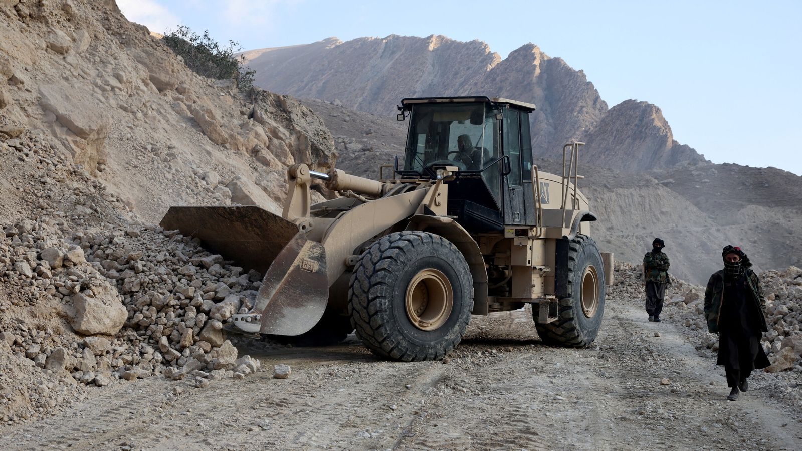 An excavator clears a road following a 2025 quake in Afghanistan's Balkh province. Pic: Reuters