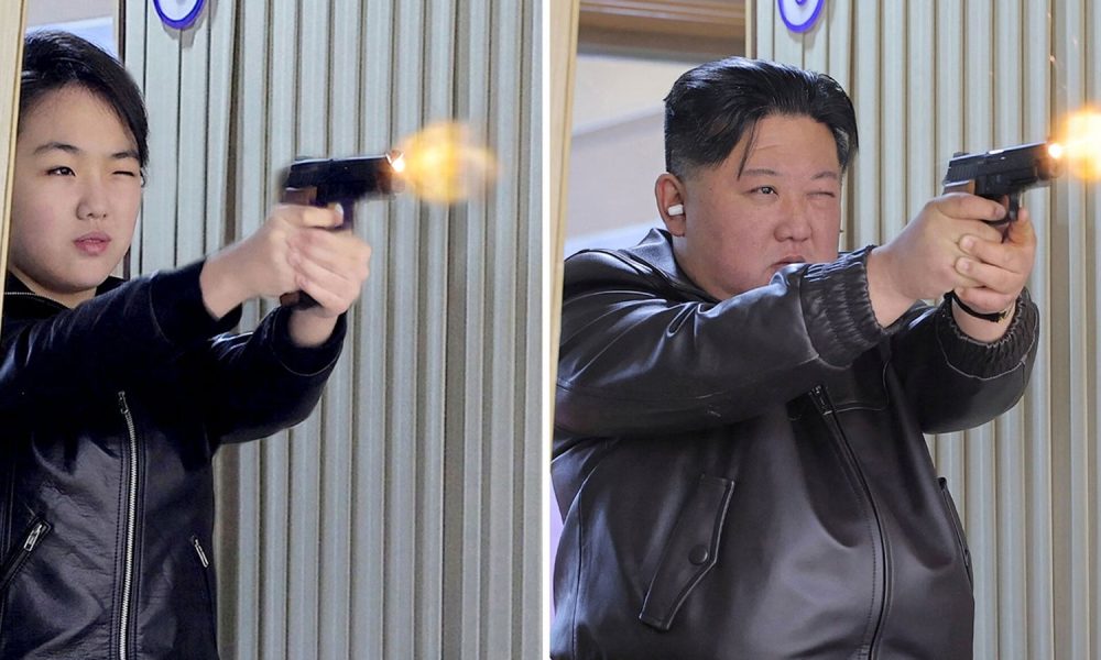 (L-R) Kim Ju Ae and Kim Jong Un fire pistols as they visit a munitions factory. Pic: Reuters