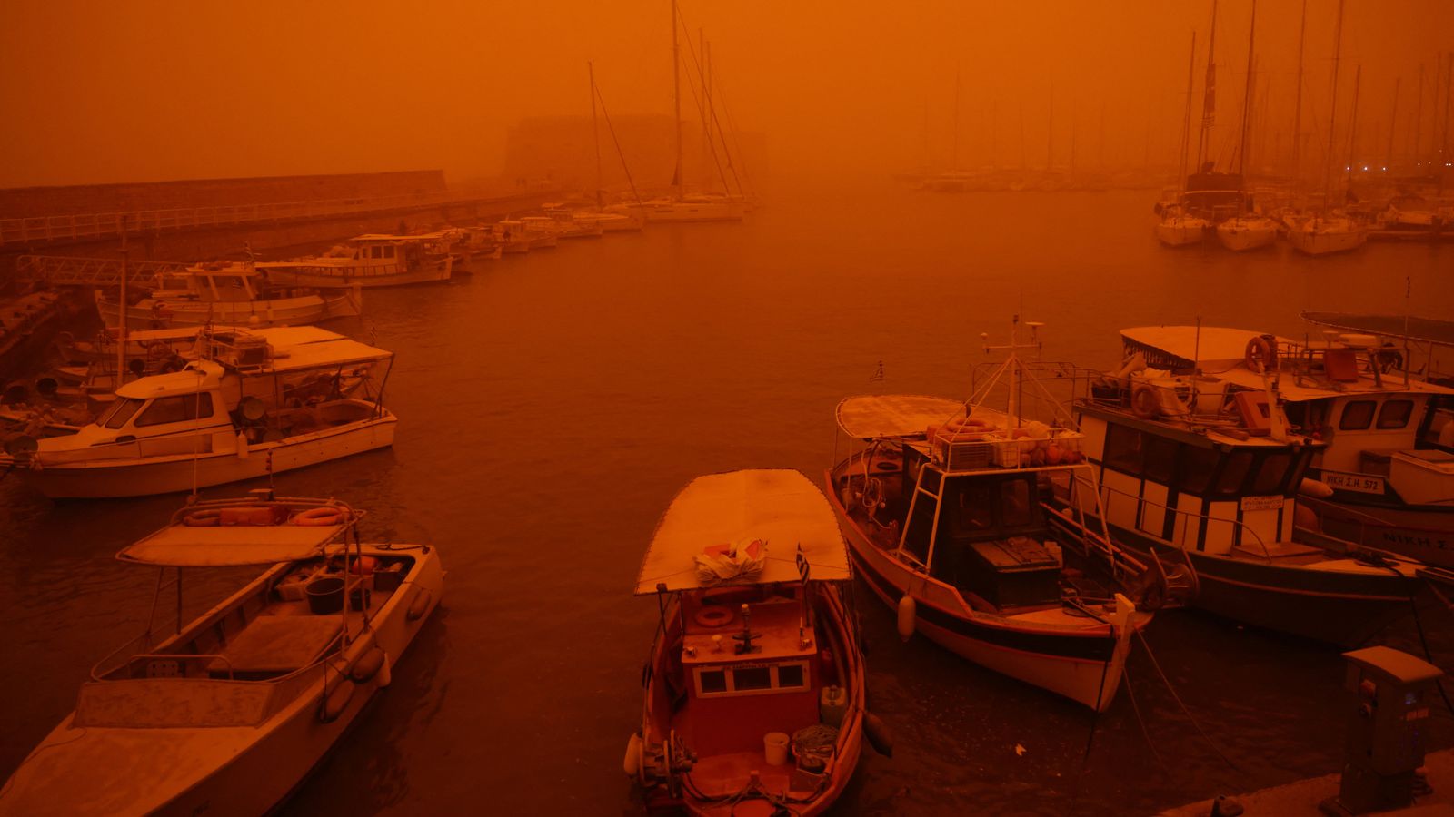A view of the port in Heraklion, Crete, which is cloaked by red dust from Africa. Pic: Reuters