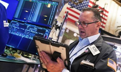 US stocks edge back from their records as oil prices swing higher