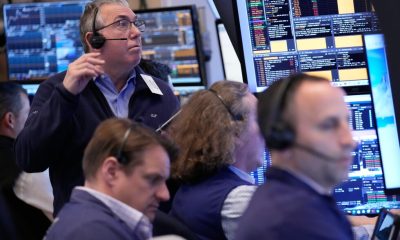 Wall Street holds near its record high even as oil prices climb