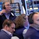 Wall Street holds near its record high even as oil prices climb