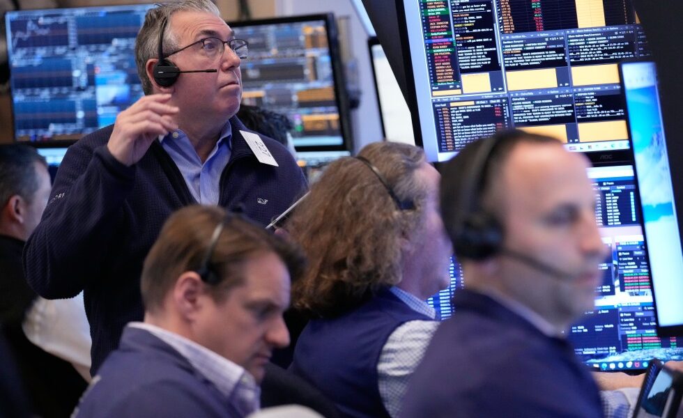Wall Street holds near its record high even as oil prices climb