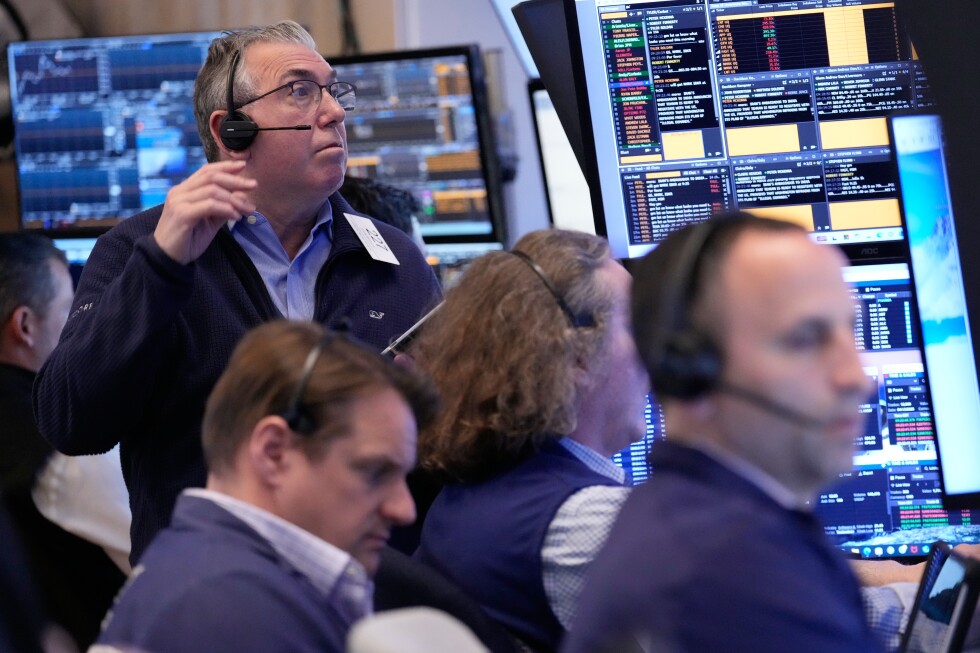 Wall Street holds near its record high even as oil prices climb