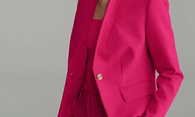 woman wears pink pantsuit