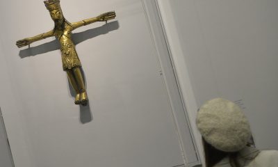 A 1,100-year-old pendent predates when Christianity was thought to have spread in Denmark. Above, a visitor views a different, twelfth century Danish copper crucifix at the British Museum in London March 4, 2014.