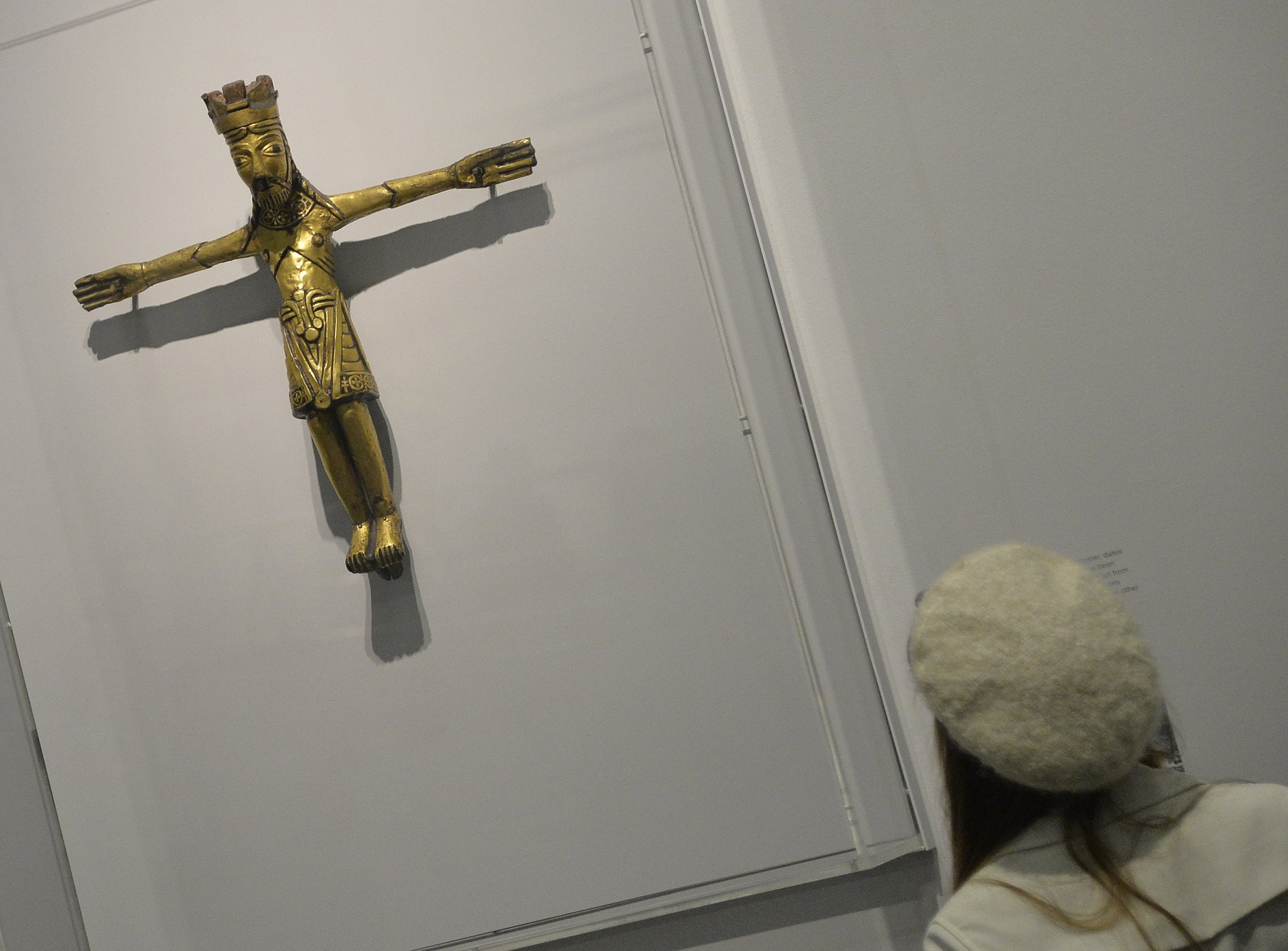 A 1,100-year-old pendent predates when Christianity was thought to have spread in Denmark. Above, a visitor views a different, twelfth century Danish copper crucifix at the British Museum in London March 4, 2014.