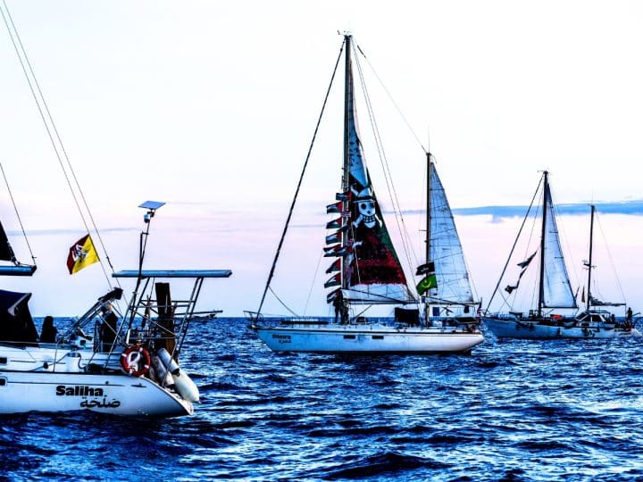 Global Sumud Flotilla boats sailing at twilight