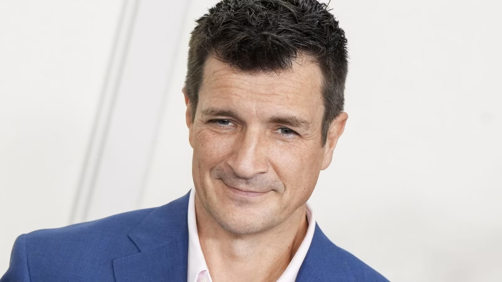 Nathan Fillion smiling at a public appearance