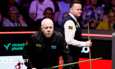 John Higgins eyes a shot